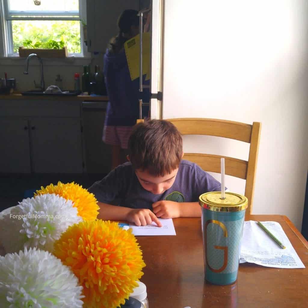 Reading & Language Arts Curriculum - boy reading at table