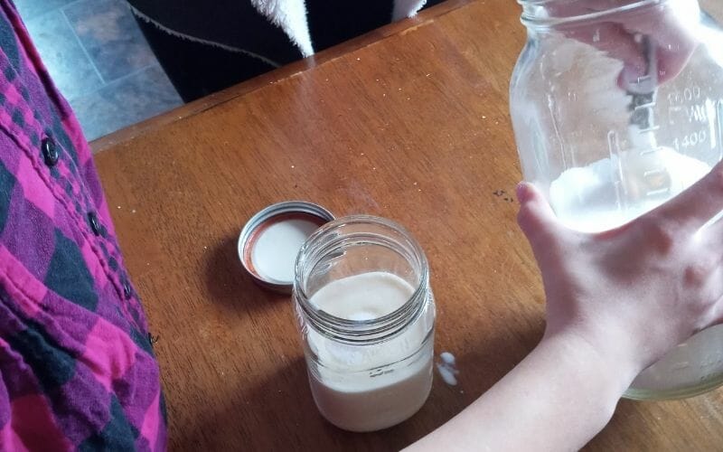 adding ingredients to ice cream in a jar