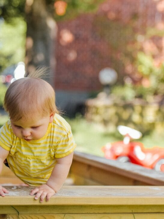 baby trying to get out of his crib