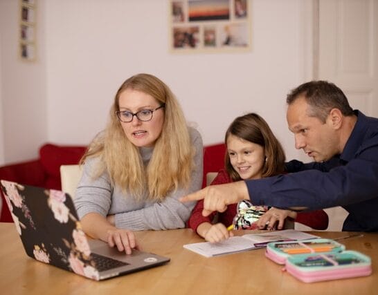 Child doing homework with parents