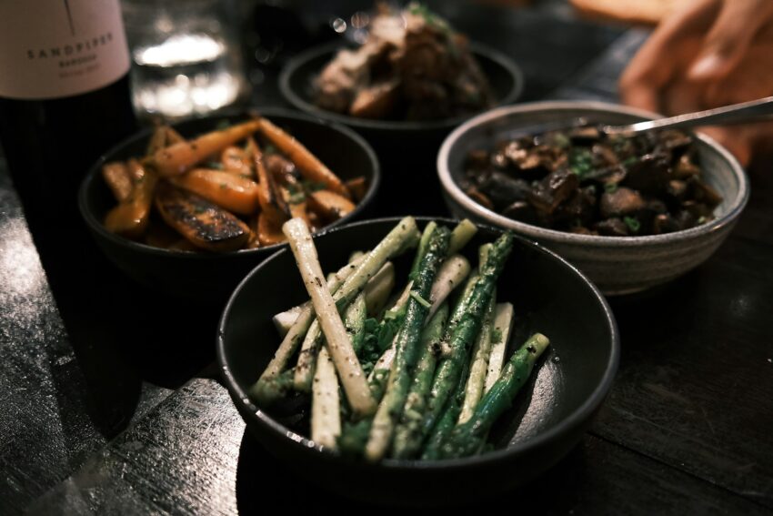 a close up of three bowls of food on a table