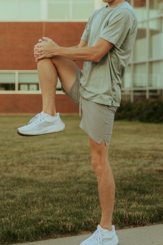 a man sitting on a skateboard on a sidewalk