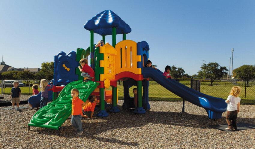 Children playing on a colorful outdoor playground structure