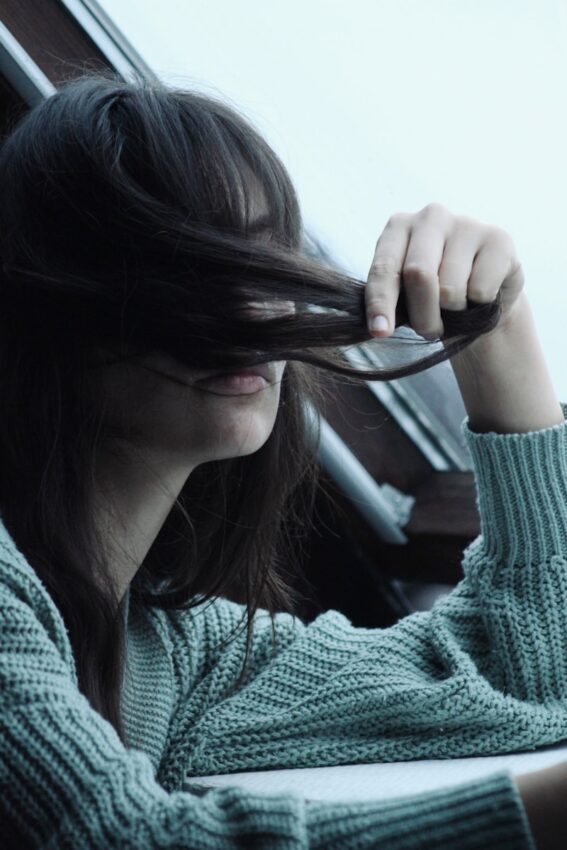 a woman with long hair sitting in a car