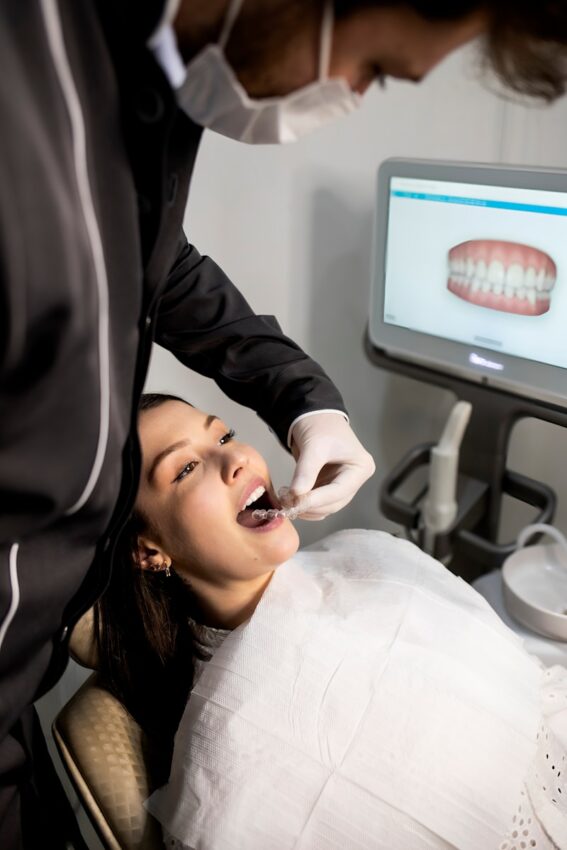 dentist examining patient with dental scanner