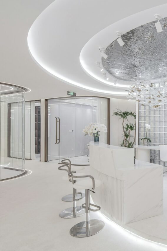 Modern white reception area with curved lines and glass partitions